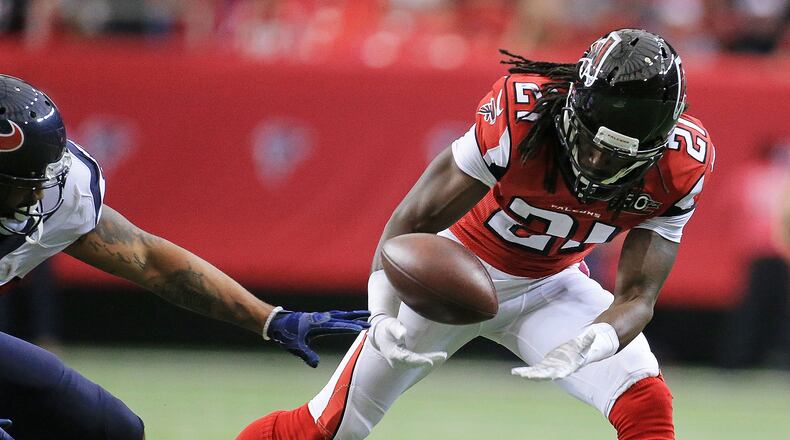 100415 ATLANTA: Falcons Desmond Trufant scoops up a Houston Texans fumble and returns it for a touchdown and a 21-0 lead during the second quarter in a football game on Sunday, Oct. 4, 2015, in Atlanta. Curtis Compton / ccompton@ajc.com