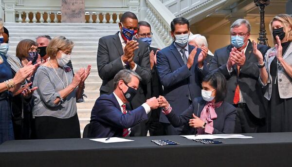 Last October, Gov. Brian Kemp celebrated with Seema Verma, then the administrator of the federal Centers for Medicare and Medicaid Services, after they agreed to a limited expansion of Medicaid benefits in Georgia. This year, President Joe Biden's administration rescinded the approval. (Hyosub Shin / hyosub.shin@ajc.com)