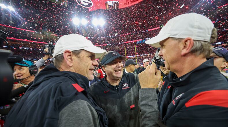 Georgia head coach Kirby Smart (center) celebrates with assistant coaches Mike Bobo (left) and Todd Monken after their win against TCU in the 2023 College Football Playoff National Championship at SoFi Stadium, in Inglewood, Calif. Georgia won 65-7. (Jason Getz /AJC)