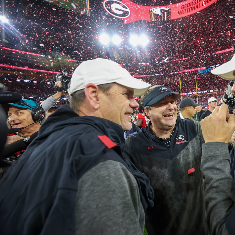 Georgia head coach Kirby Smart (center) celebrates with assistant coaches Mike Bobo (left) and Todd Monken after their win against TCU in the 2023 College Football Playoff National Championship at SoFi Stadium, in Inglewood, Calif. Georgia won 65-7. (Jason Getz /AJC)