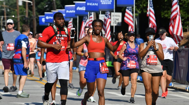 Runners make their way to cross the finish line  during the second day of 2021 Atlanta Journal-Constitution Peachtree Road Race on Sunday, July 4, 2021. (Hyosub Shin / Hyosub.Shin@ajc.com)