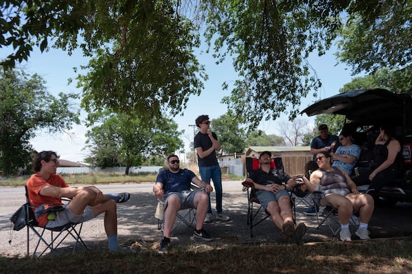 Project ICECHIP members, from left, Ethan Mok, Logan Bundy, Nathan Sonntag, Victor Gensini and Katie Wargowsky sit in chairs next to the command vehicle waiting for storms to develop Friday, June 6, 2025, in Morton, Texas. (AP Photo/Carolyn Kaster)