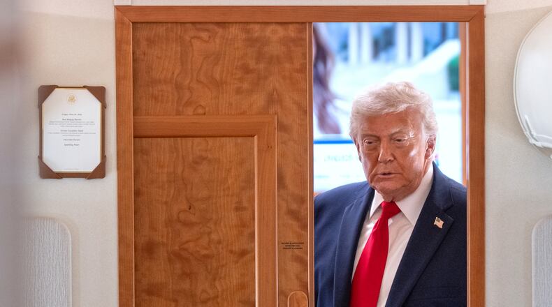 President Donald Trump arrives to speak to reporters aboard Air Force One en route from Joint Base Andrews, Md., to Eau Claire, Wis., Friday, June 5, 2026. (AP Photo/Mark Schiefelbein)