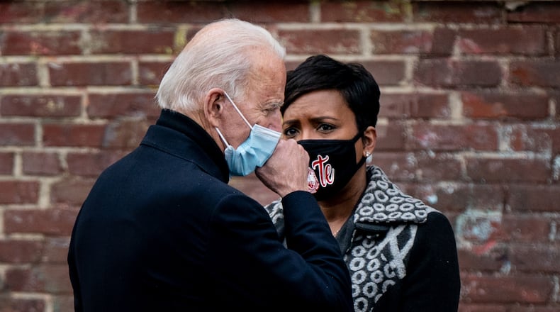 President-elect Joe Biden talks backstage with Atlanta Mayor Keisha Lance Bottoms after speaking at a campaign drive-in event in Atlanta on Tuesday, Dec. 15, 2020. Biden urged Georgia voters to cast ballots for two Democratic Senate candidates in a pair of critical runoffs early next month, seeking victories that would give his party full control of the Congress and help Democrats advance the agenda he promised on the campaign trail. (Erin Schaff/The New York Times)