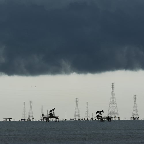 Clouds form over pumpjacks and power transmission towers on Lake Maracaibo in Cabimas, Venezuela, Tuesday, Sept. 1, 2026. (AP Photo/Ariana Cubillos)