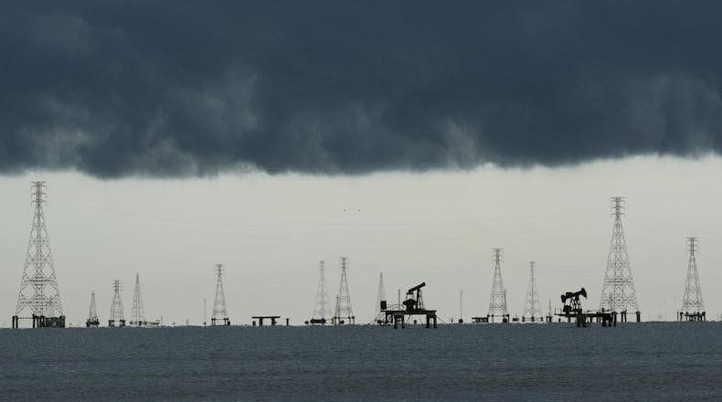 Clouds form over pumpjacks and power transmission towers on Lake Maracaibo in Cabimas, Venezuela, Tuesday, Sept. 1, 2026. (AP Photo/Ariana Cubillos)