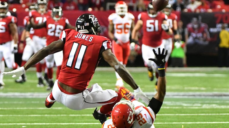 December 4, 2016 Atlanta - Atlanta Falcons wide receiver Julio Jones (11) and Kansas City Chiefs strong safety Eric Berry (29) fall onto the field after they fought for a ball during the first half in an NFL football game at the Georgia Dome on Sunday, December 4, 2016. HYOSUB SHIN / HSHIN@AJC.COM