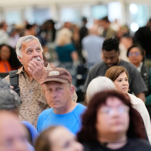 Passengers wait in a security checkpoint line at George Bush Intercontinental Airport, Wednesday, March 25, 2026, in Houston. (AP Photo/David J. Phillip)