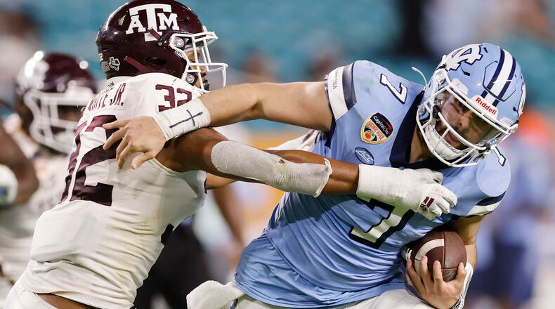 North Carolina quarterback Sam Howell is tackled by Texas A&M's Andre White. Signing day at Georgia Tech did not yield announcements of any new Yellow Jackets, which was an expected result after coach Brent Key and his staff had already brought in (and announced) 19 high school signees and 11 transfers in December and January. (Michael Reaves file photo / TNS)