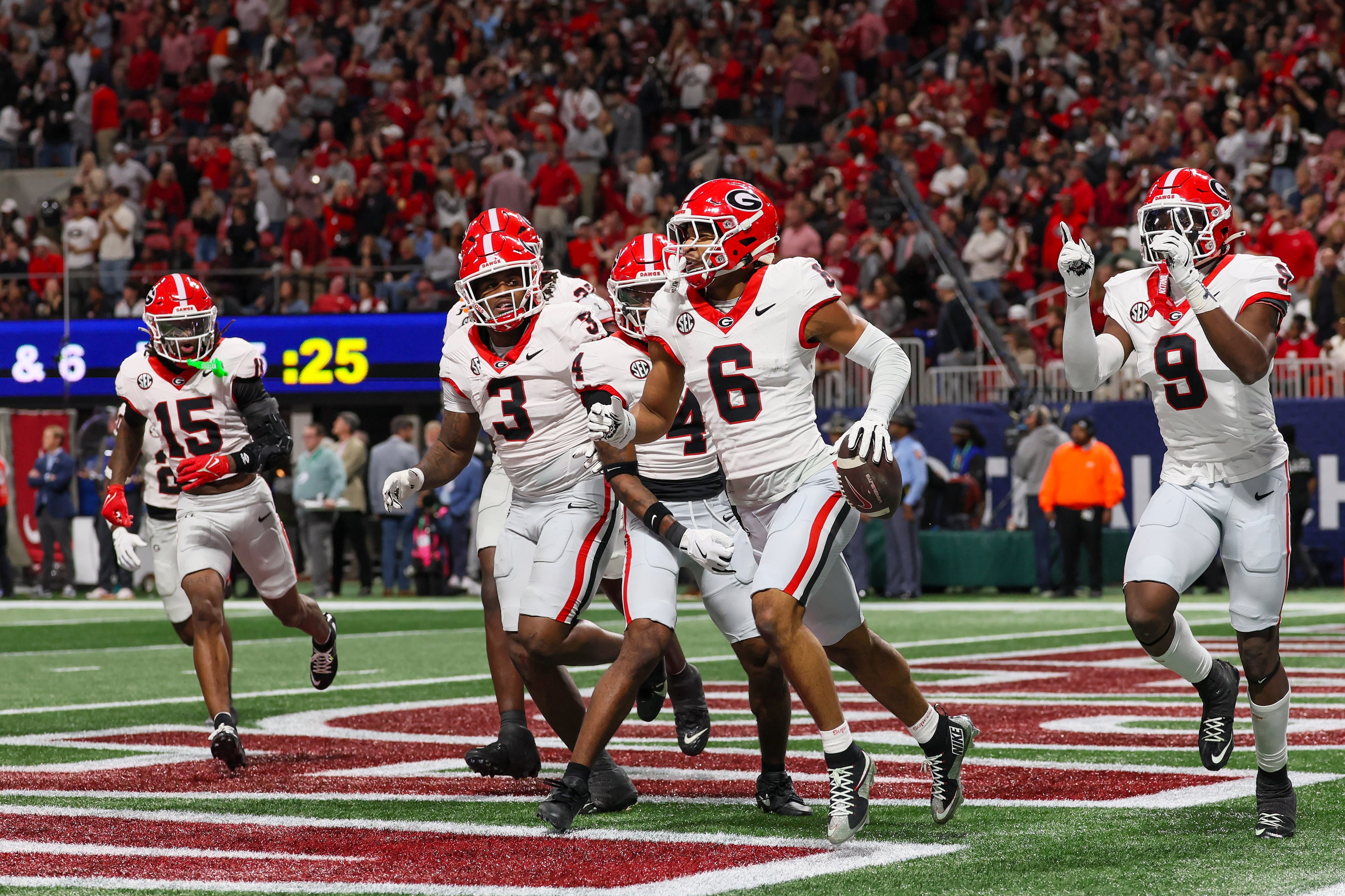 Georgia defensive back Daylen Everette (6) celebrates with teammates after an interception against Alabama during the first quarter of the SEC Championship game at Mercedes-Benz Stadium, Saturday, Dec. 6, 2025, in Atlanta. (Jason Getz / AJC)