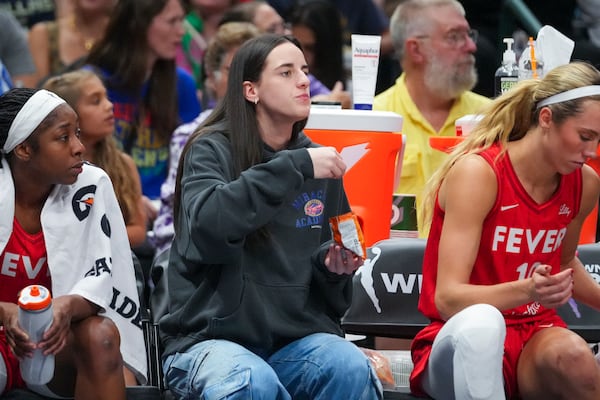 Indiana Fever guard Caitlin Clark eats Goldfish crackers during the first half of a WNBA basketball game against the Dallas Wings Friday, June 27, 2025, in Dallas. (AP Photo/Julio Cortez)
