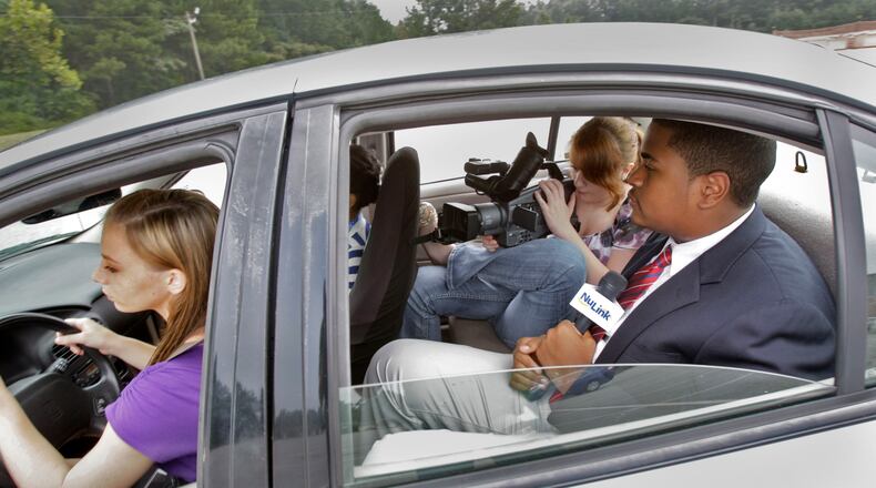 August 1, 2012 - Newnan - Amber Rogers (left) takes the wheel as Leah Gaillot and Caleb Britt film their segment on texting and driving. Students at Central Education Center, a public charter school in Cowetta County, help produce "The Link", a local cable television program. CEC has received national acclaim for its efforts in preparing students for work after high school. The students also produced their own segment on for the show on the dangers of texting and driving. BOB ANDRES / BANDRES@AJC.COM
