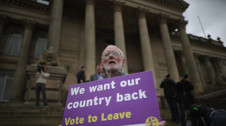BOLTON, ENGLAND - MAY 25: A Vote to Leave campaigner holds a placard as Leader of the United Kingdom Independence Party (UKIP), Nigel Farage campaigns for votes to leave the European Union in the referendum on May 25, 2016 in Bolton, England. Nigel Farage took his battle bus to Bolton encouraging British people to vote to leave the EU on 23rd June 2016. (Photo by Christopher Furlong/Getty Images)