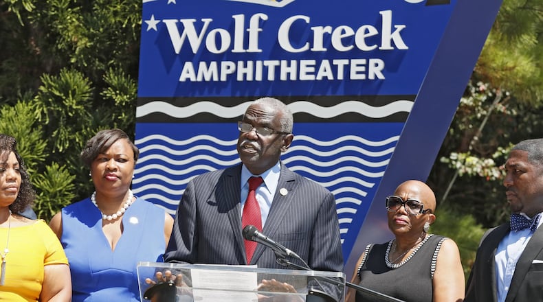 In a press conference held at the entrance to Wolf Creek Amphitheater, the Mayor of South Fulton, Bill Edwards (center), along with city leaders, announced the city is suing Fulton County for control of libraries, Wolf Creek amphitheater and other buildings.