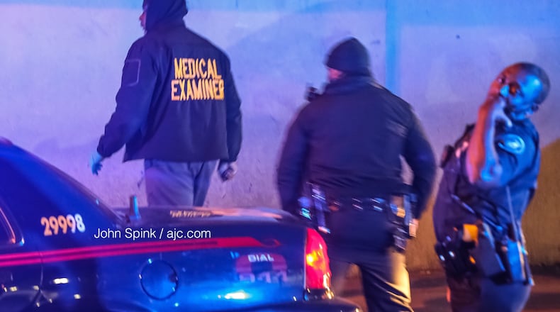 An investigator with the Fulton County Medical Examiner's Office arrives on Peachtree Street after a man's body was found.