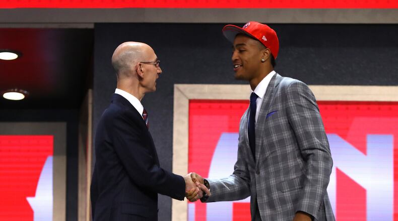John Collins walks on stage with NBA commissioner Adam Silver after being drafted 19th overall by the Atlanta Hawks during the first round of the 2017 NBA Draft at Barclays Center on June 22, 2017 in New York City. (Photo by Mike Stobe/Getty Images)