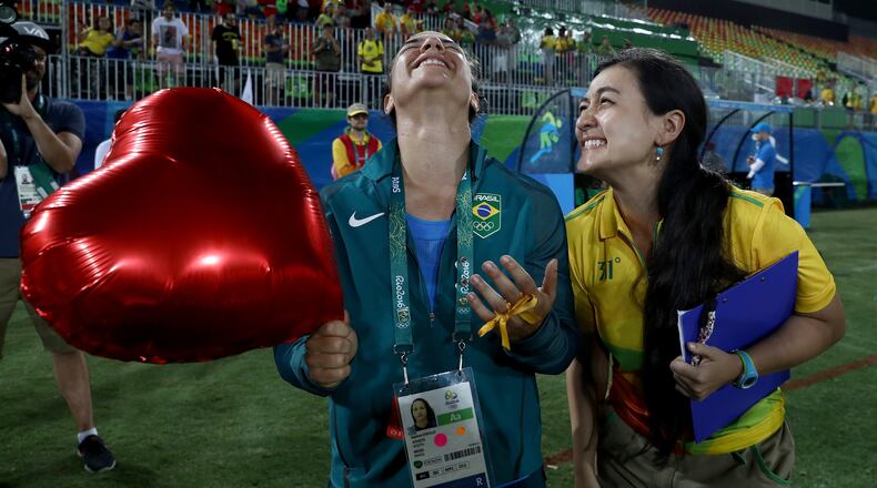 RIO DE JANEIRO, BRAZIL - AUGUST 08: Volunteer Marjorie Enya (R) and rugby player Isadora Cerullo of Brazil smile after proposing marriage after the Women's Gold Medal Rugby Sevens match between Australia and New Zealand on Day 3 of the Rio 2016 Olympic Games at the Deodoro Stadium on August 8, 2016 in Rio de Janeiro, Brazil. (Photo by David Rogers/Getty Images)