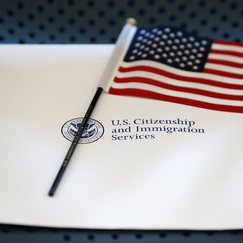 FILE - An information packet and an American flag are placed on a chair at the U.S. Citizenship and Immigration Services Miami Field Office on Aug. 17, 2018, in Miami. (AP Photo/Wilfredo Lee, File)