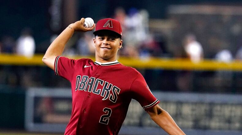 Arizona Diamondbacks first round MLB draft pick Druw Jones throws out the first pitch prior to a baseball game against the Washington Nationals Saturday, July 23, 2022, in Phoenix. (AP Photo/Ross D. Franklin)