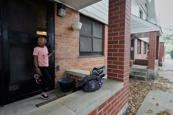 Nova Brown, 5, stands outside her home at a public housing complex before going to school on Wednesday, April 2, 2025, in Houston. (AP Photo/Ashley Landis)