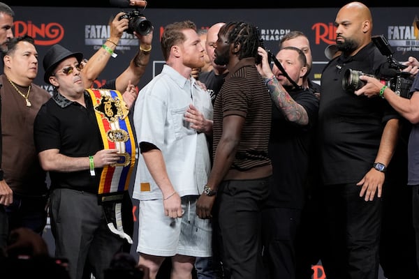 Canelo Alvarez, left, and Terence Crawford face off during a news conference for their upcoming boxing match Friday, June 27, 2025, in Las Vegas. (AP Photo/John Locher)