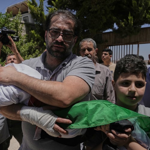 Fahd Abu Haikal, 41 carries the body of his seven month old Palestinian baby boy Sam, who was killed on Friday when, according to the Palestinian health ministry, Israeli soldiers fired at the vehicle carrying him and his parents in Tel Rumeida, during his funeral in the West Bank city of Hebron, Saturday, June 6, 2026. (AP Photo/Mahmoud Illean)