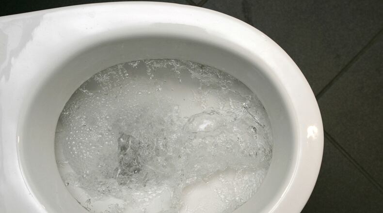 Water swirls in a flushing toilet.