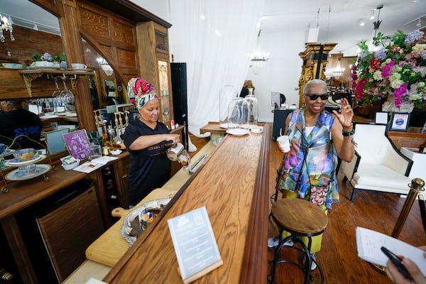 Dorthey Hurst (right), chair of the Public Safety Committee with NPU M, speaks as Jamell McDowell (left) prepares a coffee at her Purple Door Salon on Wednesday, July 30, 2025. Businesses and residents are working to recover after recent shootings in Sweet Auburn.
(Miguel Martinez/AJC)