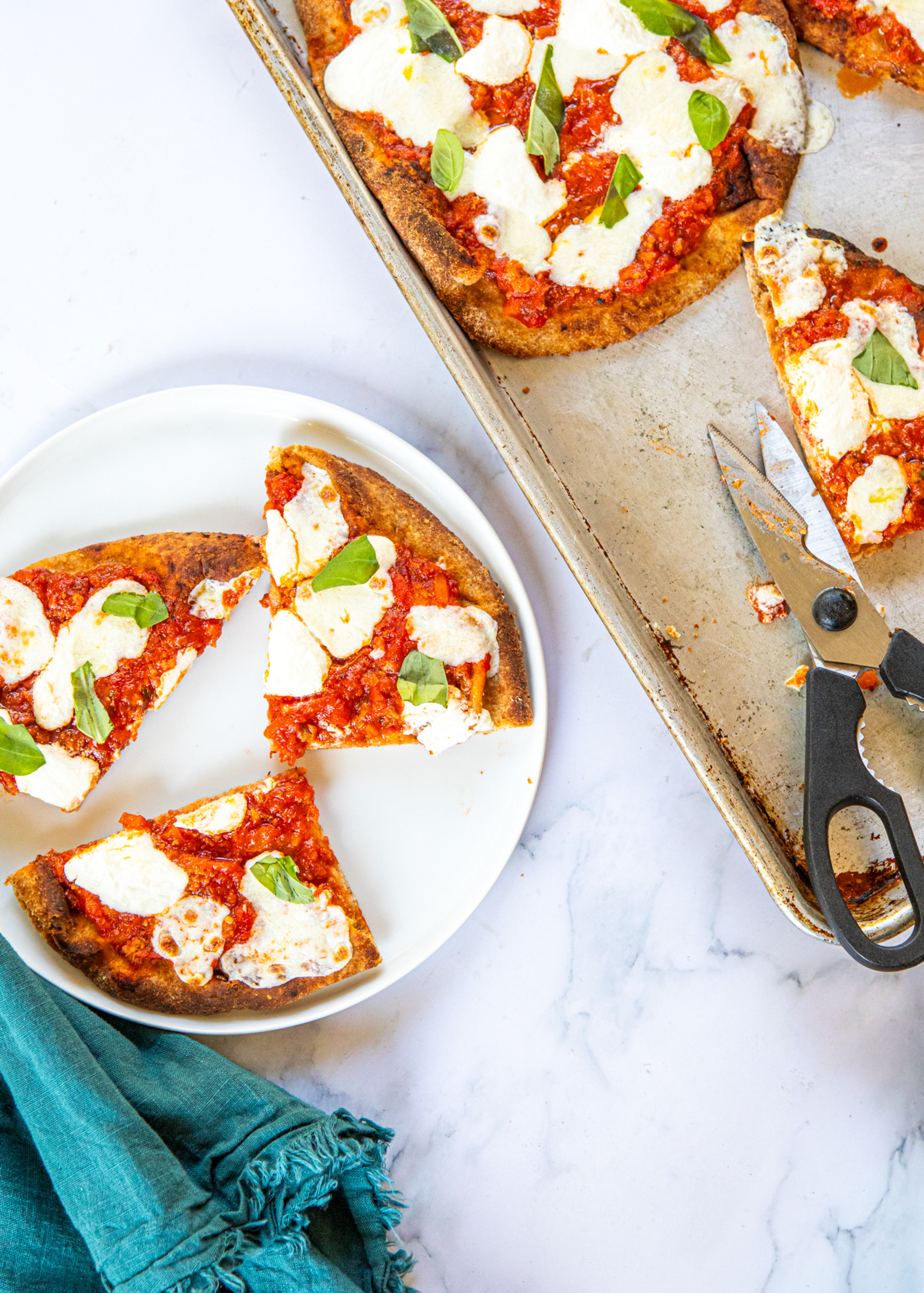 Naan provides a simple stand-in for the crust in homemade versions of the Bolognese pizza from Lloyd's Restaurant and Lounge in Inman Park. (Credit: Aaliyah Mann for the AJC, styling by Kate Itrich-Williams)