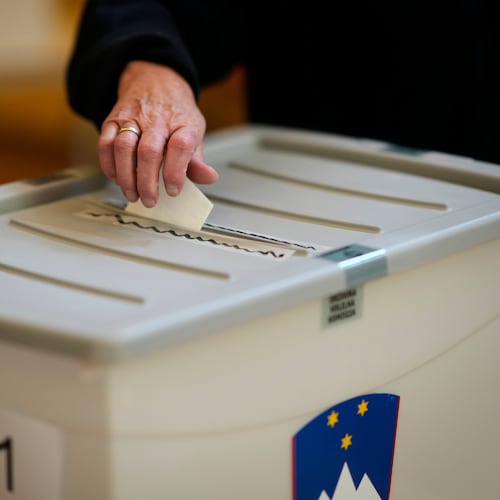 A voter casts her ballot at a polling station during the referendum on assisted dying for terminally ill patients, in Domzale, Slovenia, Sunday, Nov. 23, 2025. (AP Photo/Darko Bandic)