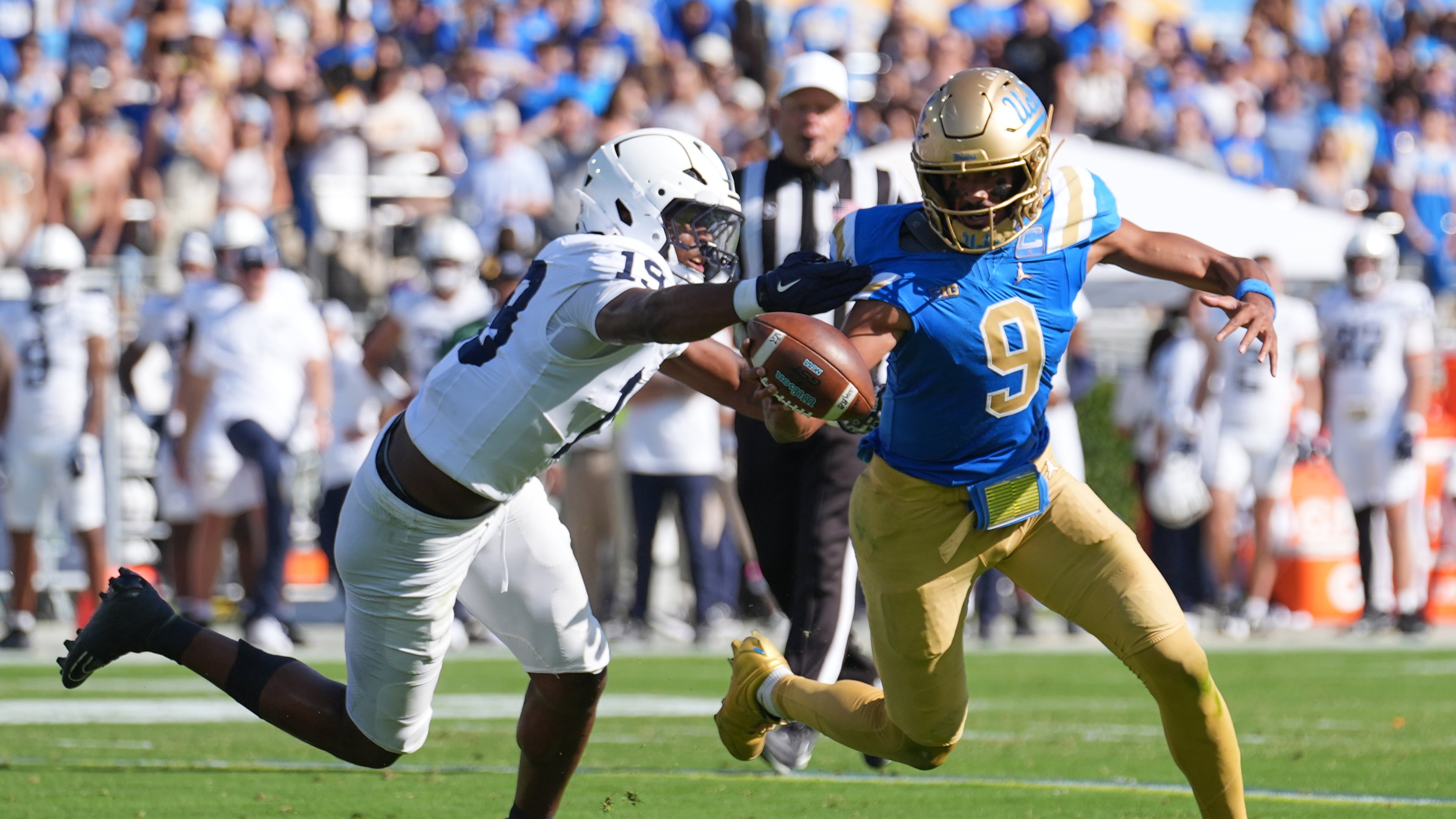 UCLA quarterback Nico Iamaleava (9) runs past Penn State defensive end Chaz Coleman (19) during the second half of an NCAA college football game Saturday, Oct. 4, 2025, in Pasadena, Calif. (AP Photo/Marcio Jose Sanchez)