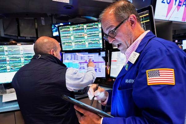 Trader Mark Puetzer, right, works on the floor of the New York Stock Exchange, Tuesday, April 29, 2025. (AP Photo/Richard Drew)