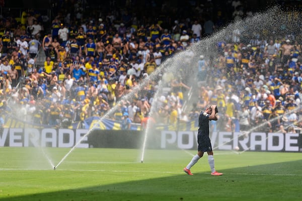 FILE - Auckland City's Gerard Garriga cools off under the sprinklers during a water break in the Club World Cup Group C soccer match between Auckland City and Boca Juniors in Nashville, Tenn., Tuesday, June 24, 2025. (AP Photo/George Walker IV, File)