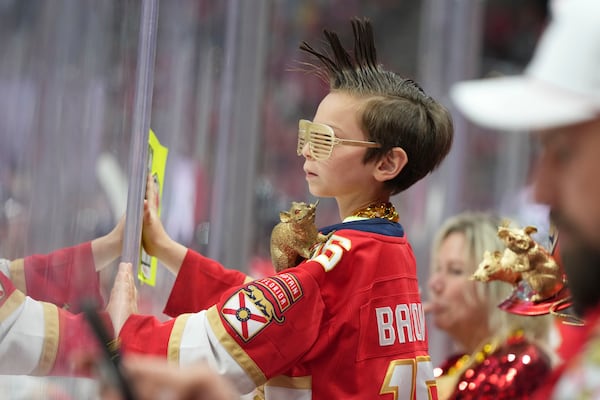 A young Florida Panthers fan watches during the first period in Game 4 of the NHL hockey Stanley Cup Eastern Conference finals against the Carolina Hurricanes, Monday, May 26, 2025, in Sunrise, Fla. (AP Photo/Lynne Sladky)