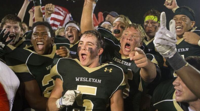 Wesleyan Wolves football players celebrate their 18-9 victory over Pace Academy Knights at home in Peachtree Corners on Friday September 25, 2015. (Phil Skinner/Special) to the AJC