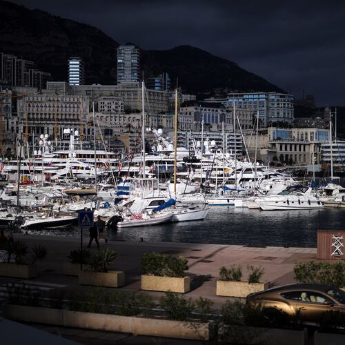 FILE - A luxury car drives along Monaco Harbor, Nov. 19, 2020. (AP Photo/Daniel Cole, File)