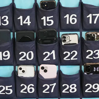 A phone holder hangs in a classroom at Delta High School in Utah in February 2024. Utah is one of the dozens of states in the U.S. that ban the use of cellphones in school. Georgia joined their ranks last year with a ban for K-8 students beginning in 2026-27, and lawmakers are interested in expanding that ban during this year's legislative session. (Rick Bowmer/AP 2024)