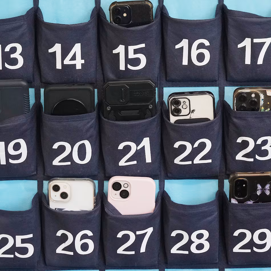 A phone holder hangs in a classroom at Delta High School in Utah in February 2024. Utah is one of the dozens of states in the U.S. that ban the use of cellphones in school. Georgia joined their ranks last year with a ban for K-8 students beginning in 2026-27, and lawmakers are interested in expanding that ban during this year's legislative session. (Rick Bowmer/AP 2024)