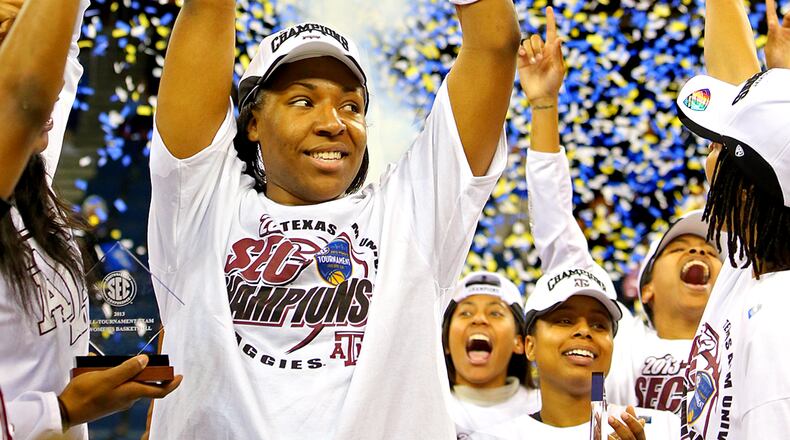 ****POSSIBLE LEAD IMAGE****031013 DULUTH: Texas A&M center Kelsey Bone, the games MVP with 18 points, hoists the SEC trophy celebrating with teammates after defeating Kentucky 75-67 to win the SEC women's tournament championship on Sunday, March 10, 2013, in Duluth. CURTIS COMPTON / CCOMPTON@AJC.COM