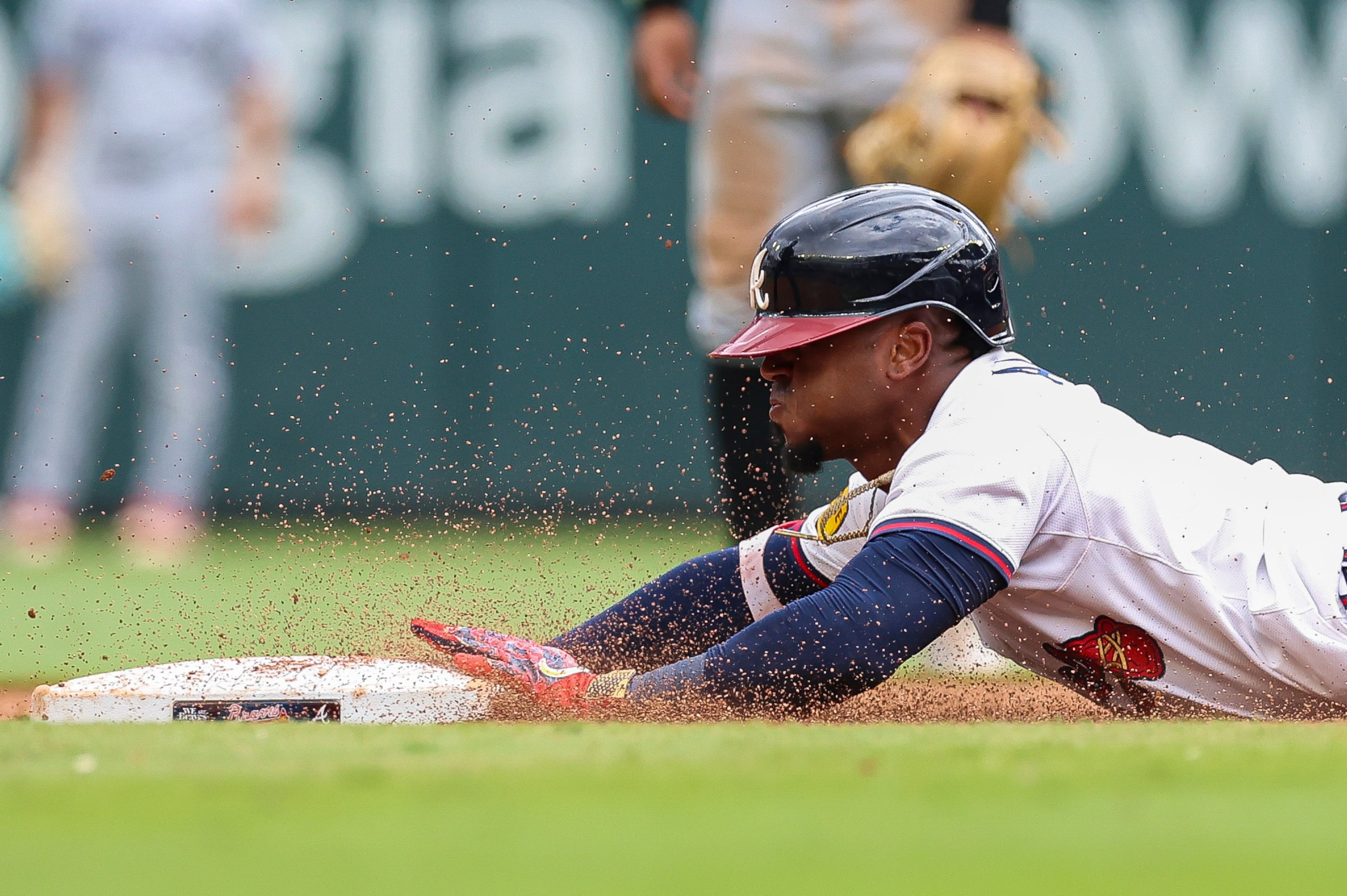 Braves infielder Ozzie Albies slides into second Sunday.