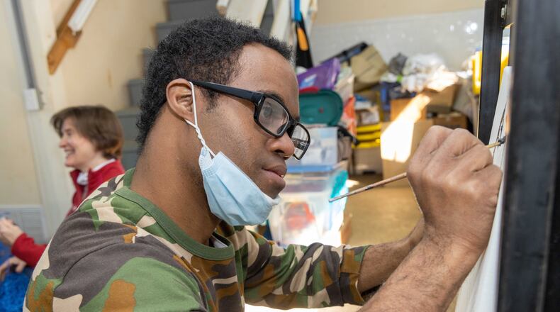 Chad Boddie works on his painting in art class at the Friendship Center of Atlanta.
 PHIL SKINNER FOR THE ATLANTA JOURNAL-CONSTITUTION