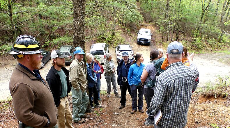 Members of the Georgia Botanical Society meet with U.S. Forest Service personnel to discuss the use of prescribed burning at Mulky Gap in the Chattahoochee National Forest in Union County. A "prescribed fire" two years ago burned hundreds of blooming pink lady's slippers. (Charles Seabrook for The Atlanta Journal-Constitution)