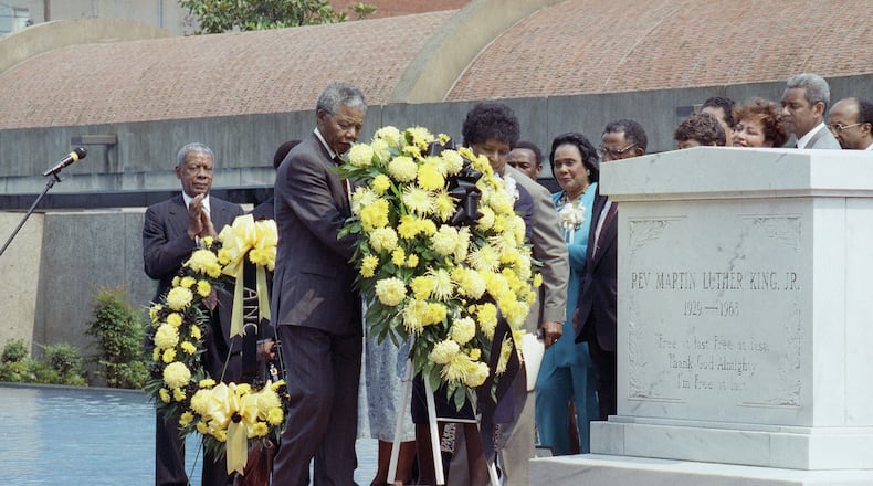 Nelson Mandela, deputy president of the African National Congress, and his wife Winnie place a wreath at the tomb of the Rev. Martin Luther King Jr. in Atlanta.
