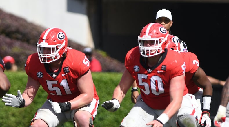 Georgia offensive lineman Tate Ratledge (51), and Warren Ericson (50) were working side--by-side with the No. 1 offense in the G-Day game last April. Now Ratledge is out with a foot injury and Ericson has taken over at right guard while still healing with a broken left hand.  (Photo by Rob Davis/UGA Athletics)