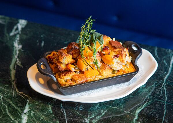 The Betty’s Savory Butternut Squash Bread Pudding is made with sage, dried cherries and bourbon. (Aaliyah Man for The Atlanta Journal-Constitution)