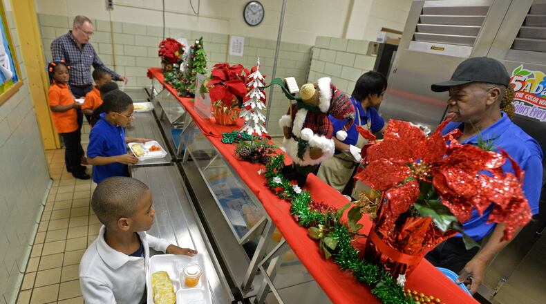 Some 11,500 part-time cafeteria workers and bus drivers would be cut from the state health insurance plan under a proposal by Gov. Nathan Deal to trim expenses in the state-subsidized plan. A lunch line at Columbia Elementary School in Decatur. HYOSUB SHIN / HSHIN@AJC.COM