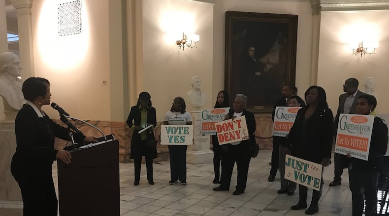 Kathryn Rice speaks in favor of creating the city of Greenhaven as supporters hold signs during a press conference at the State Capitol on Feb. 15, 2018.
