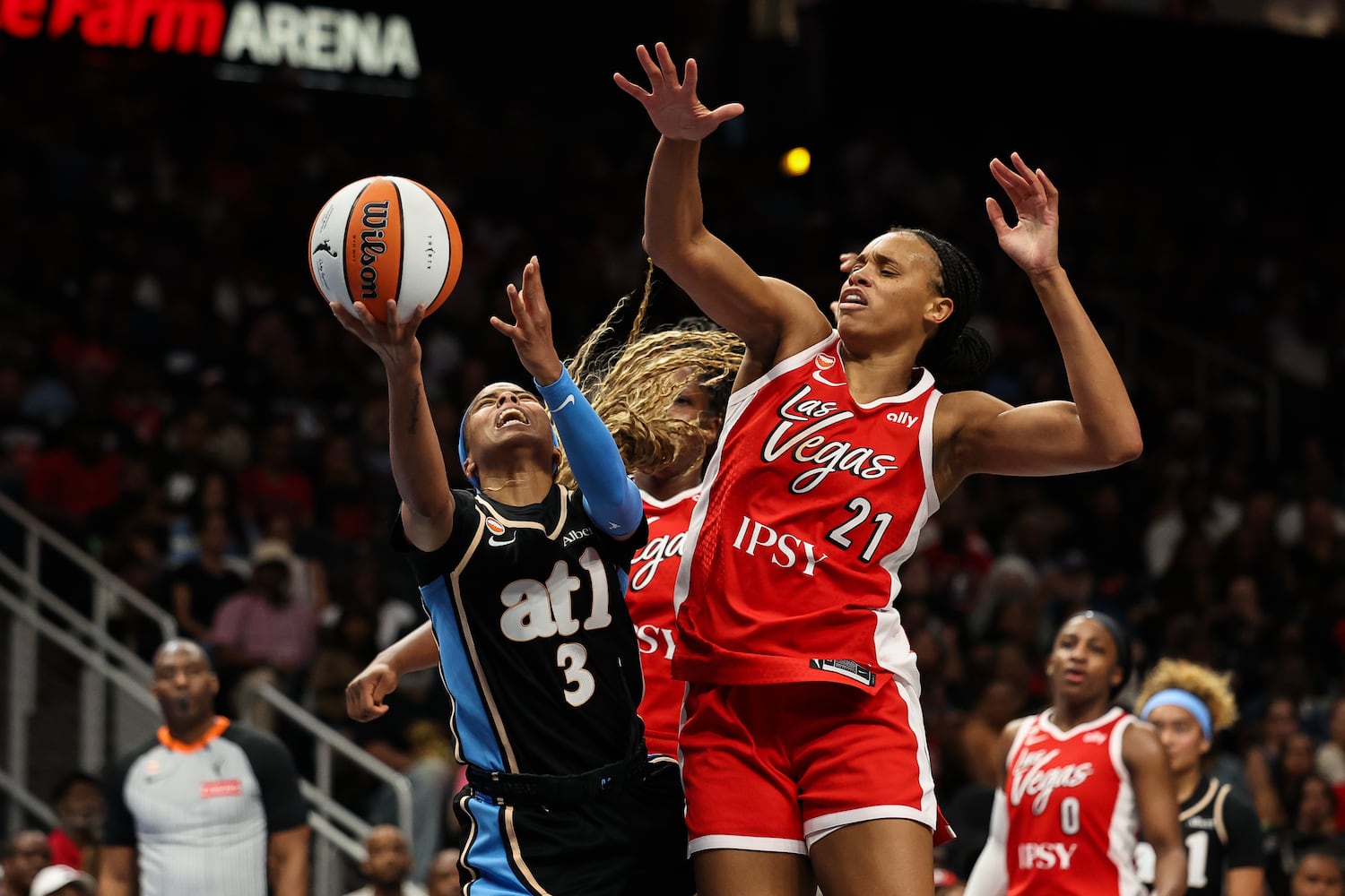 Dream guard Jordin Canada (left) shoots against Aces forward Brianna Turner (right) during the first half Sunday, May 17, 2026, at State Farm Arena in Atlanta. (Colin Hubbard for the AJC) 