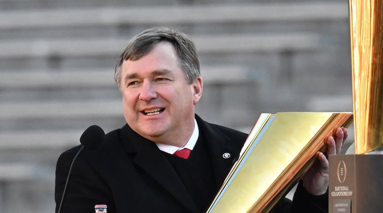 Georgia's head coach Kirby Smart holds the National Championship trophy during the celebration of the Bulldogs going back-to-back to win the 2022 National Championship at Sanford Stadium, Saturday, Jan. 14, 2023, in Athens. (Hyosub Shin / Hyosub.Shin@ajc.com)