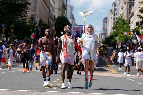 Participants march during the World Pride parade, Saturday, June 7, 2025, in Washington. (AP Photo/Mark Schiefelbein)